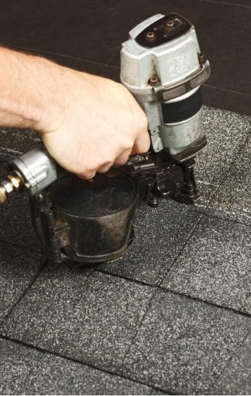 Shingles being Nailed to Roof | Roof Replacements